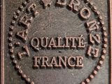 an image of a close up of a metal plaque with a logo on it