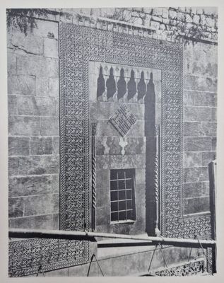 a black and white photo of a building with a window