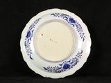 blue and white plate with a red dot in the center