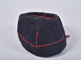 a black hat with red stitching on it on a white surface
