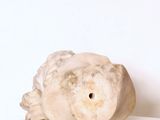 a white sculpture of a fish on a white surface