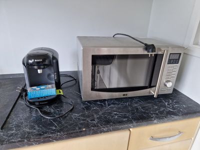 a microwave and a coffee maker sitting on a counter