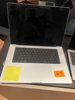 two laptops sitting on a table with sticky notes on them