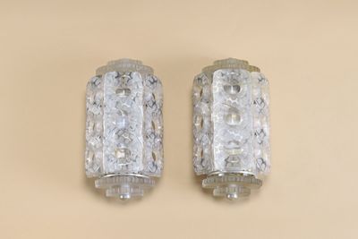two glass bottles that are sitting on a table