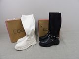 two pairs of black and white boots sitting next to each other