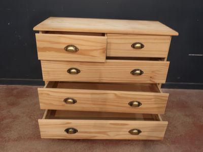 une commode en bois à trois tiroirs