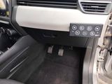 a car dashboard with a control panel and a steering wheel