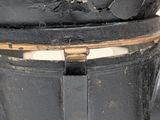 a black trash can with a black lid and a brown handle