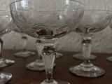 several empty wine glasses sitting on top of a wooden table
