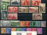 a lot of stamps that are on display on a table