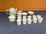 many cups and saucers sitting on a table