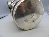 a silver purse that is sitting on a table