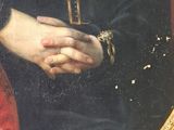 portrait of a woman in a black dress holding a golden cross