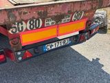 an image of a flatbed truck parked on the side of the road