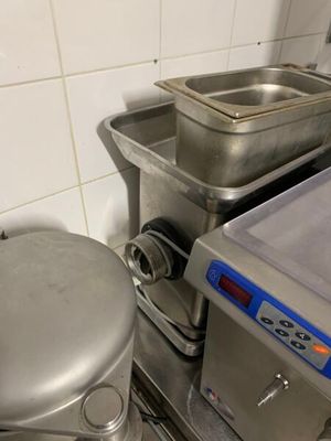un mixeur argenté posé à côté d'une casserole en métal
