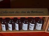 many bottles of wine in a wooden box on a table