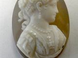 an image of a woman ' s profile is shown in a carved shell