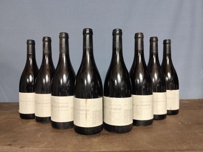 six bottles of wine are lined up in a row on a table