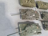 a lot of toy tanks that are sitting on a table