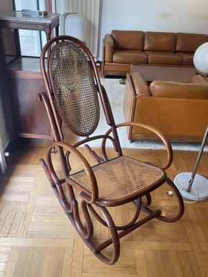 a rocking chair in the middle of a living room