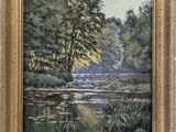 une peinture à l'huile représentant une rivière et des arbres, dans un cadre doré