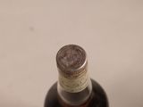 a bottle of liquor sitting on a white surface
