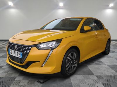 a yellow car parked in a garage with a checkered floor