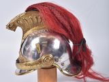 helmet of a roman soldier with red hair on a wooden stand