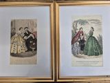 two framed prints of ladies in dresses and hats on a table