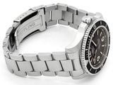 a watch that is sitting on a bracelet on a white surface