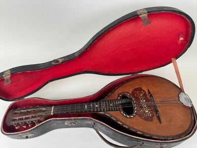 a guitar inside of a case on a white surface