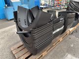 a close up of a pile of black plastic parts on a pallet