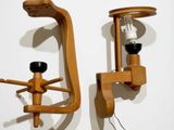 two wooden sconces that are attached to a wall