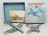 two model airplanes are sitting in a box on a white surface