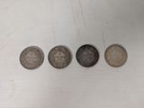 four different types of coins are shown in a row on a white surface