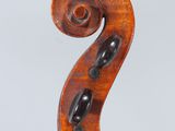 an old violin with a very long neck and a very long tail
