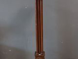 a tall wooden pedestal with a clock on top of it