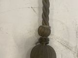 a long rope with a knot on it hanging on a wall
