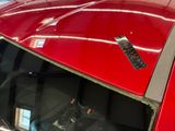 a remote control on the hood of a red car