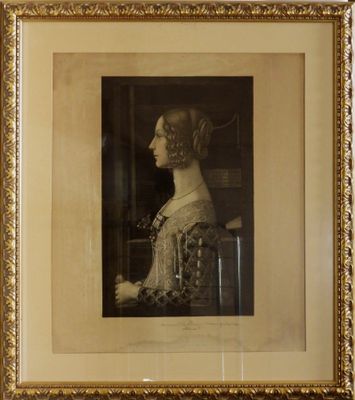 an old picture of a woman in a dress and a hat