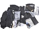 a pile of clothes and other items on a white surface
