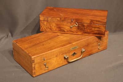 pair of antique wooden suitcases with brass handles