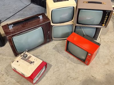 four televisions sitting on the floor next to each other