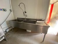 Une plonge en inox à 2 bacs et 1 égouttoir, avec douchette D…