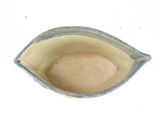 a small blue and white bowl on a white surface