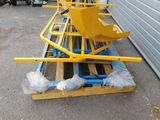 a yellow machine that is sitting on top of a pallet
