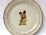 a small plate with a picture of a woman on it