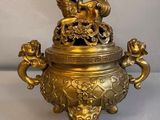 an antique brass urn with chers and chers on it