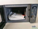 a microwave that has a bunch of papers inside of it