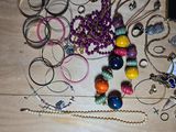 a lot of beads and bracelets laid out on a table